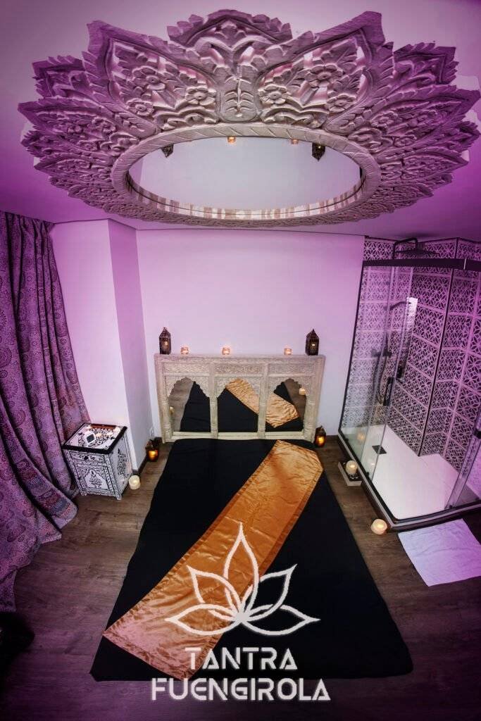 Carved mandala ceiling above the floor level bed in the Morocco massage room in Fuengirola